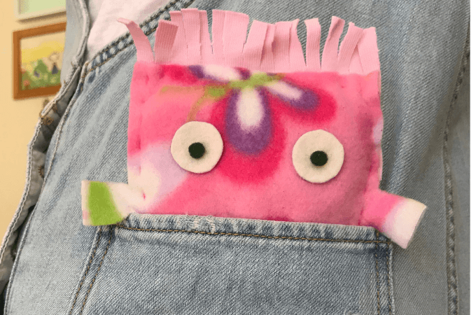 a hand sewn softie in a jeans pocketpocket